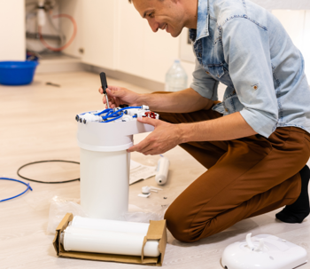 Plumber working on water filter