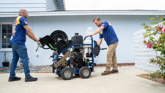 Licensed Wish Granted Plumbing technician performing eco-safe hydro jetting on residential sewer line in Huntington Beach, California