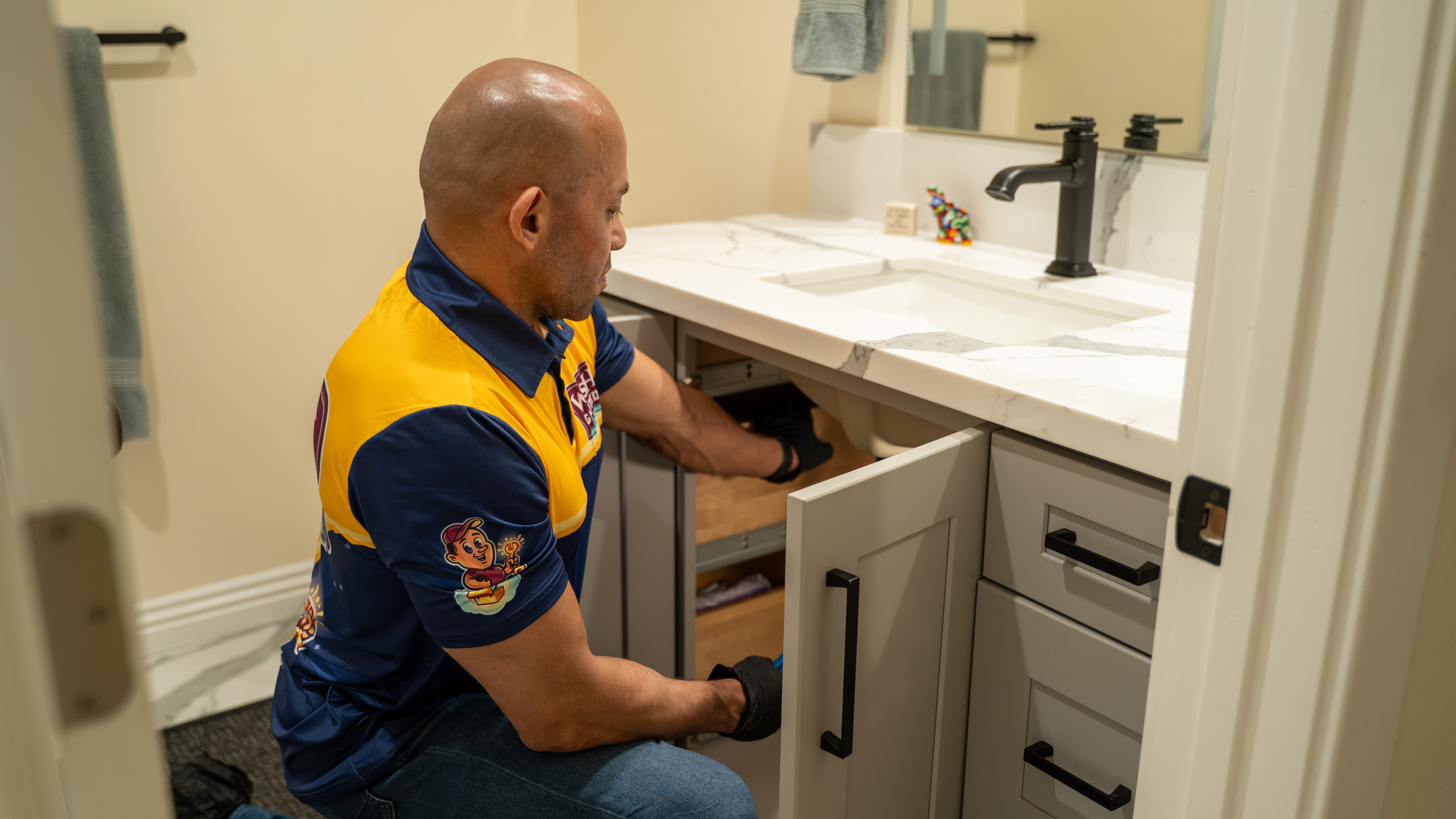 Professional plumber using tools during emergency plumbing repair